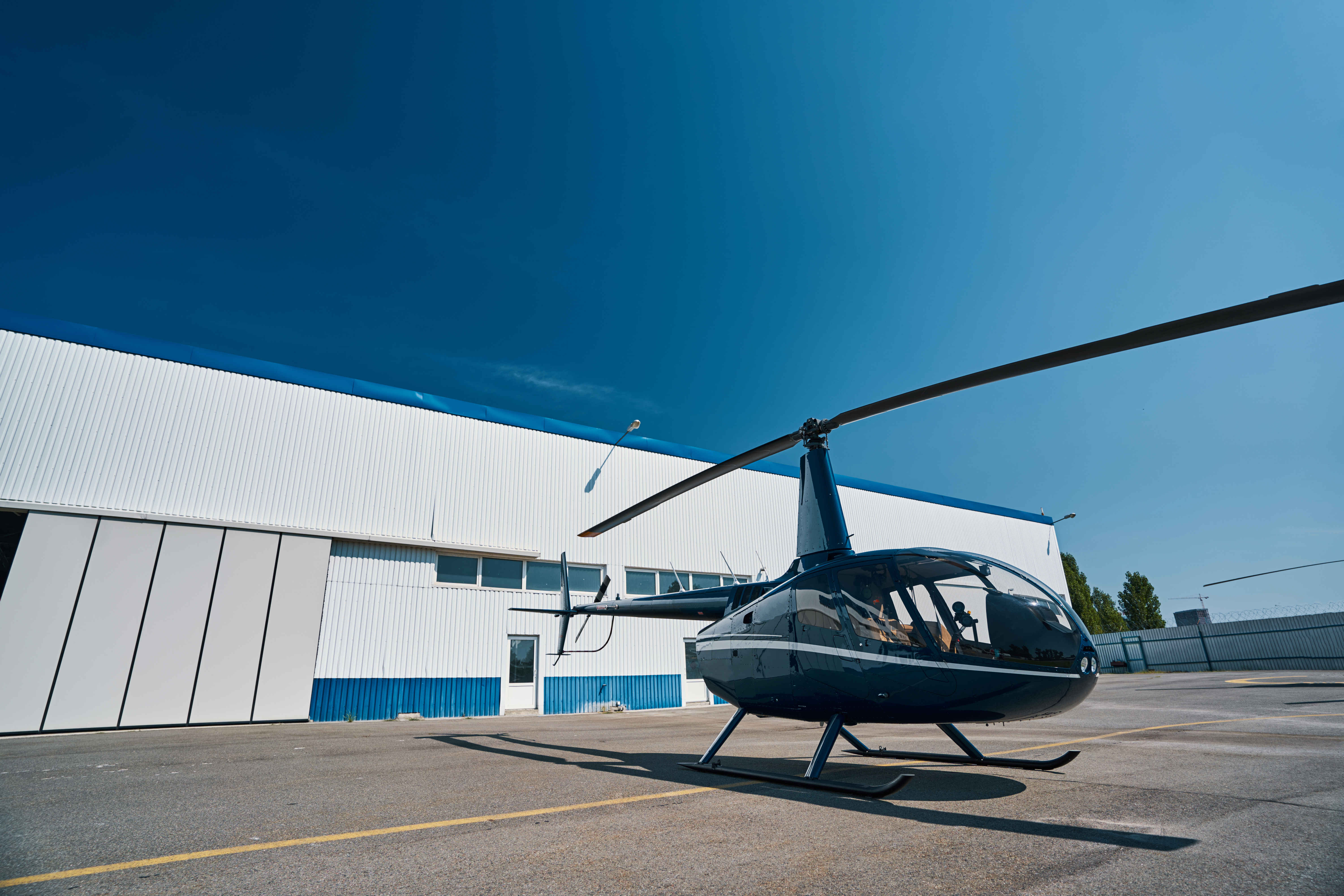 helicopter-parked-on-concrete-helipad-at-heliport-2021-10-04-23-52-44-utc